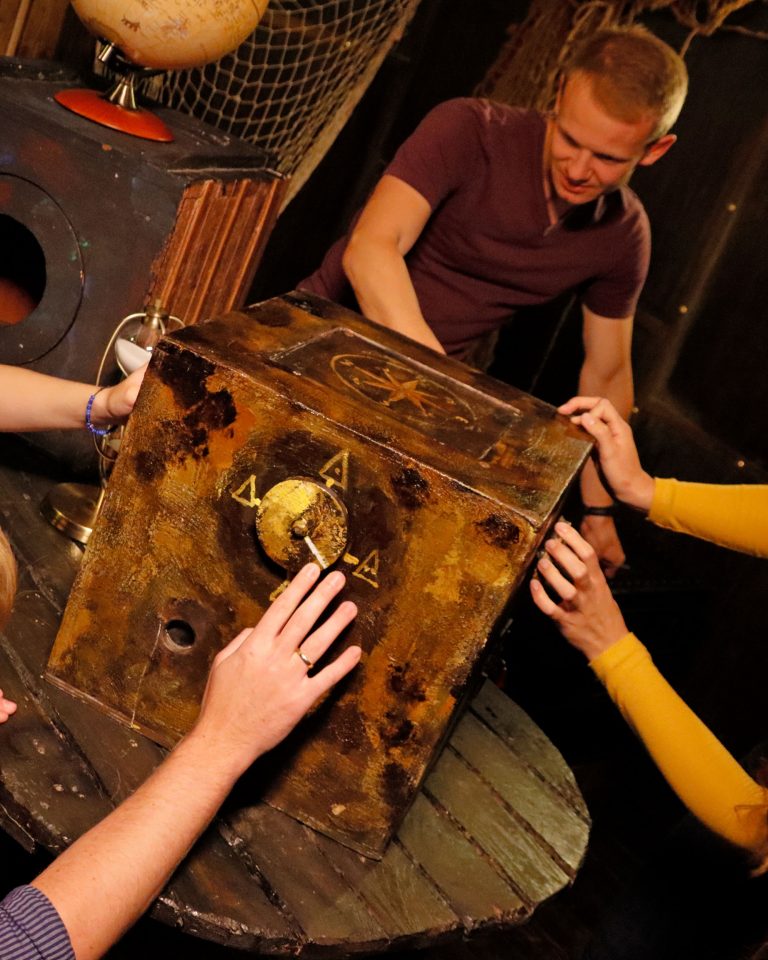 In Teamarbeit versucht eine Gruppe das Rätsel einer großen Box auf der Black Pearl zu lösen.
